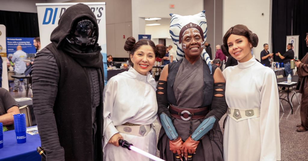 Four Workforce Board members, including Juliet Stipeche, stand together smiling and wearing Star Wars costumes.