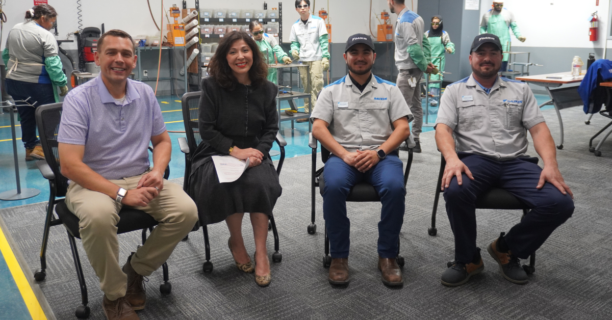 Workforce Solutions Gulf Coast Executive Director Juliet Stipeche, sitting between Daikin staff members.