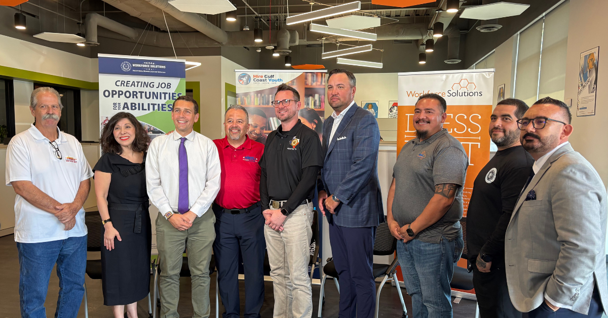 Workforce Solutions Executive Director Juliet Stipeche, next to Juan Granado, a training coordinator for the Apprenticeship Readiness Program/Multi-Craft Core Curriculum program (ARP/MC3); Paul Puente of the Houston Gulf Coast Building & Construction Trades Council; and Ryan Schuette, Business Manager for the Elevator Construction Union (IUEC 31), all standing in a Workforce Solutions office.