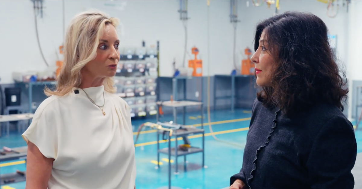 Daikin Video Executive Director Juliet K. Stipeche speaking with Wendy Hall, Senior Director of Communications, Culture & Community Engagement for Daikin Comfort Technologies North America, inside a Daikin facility.