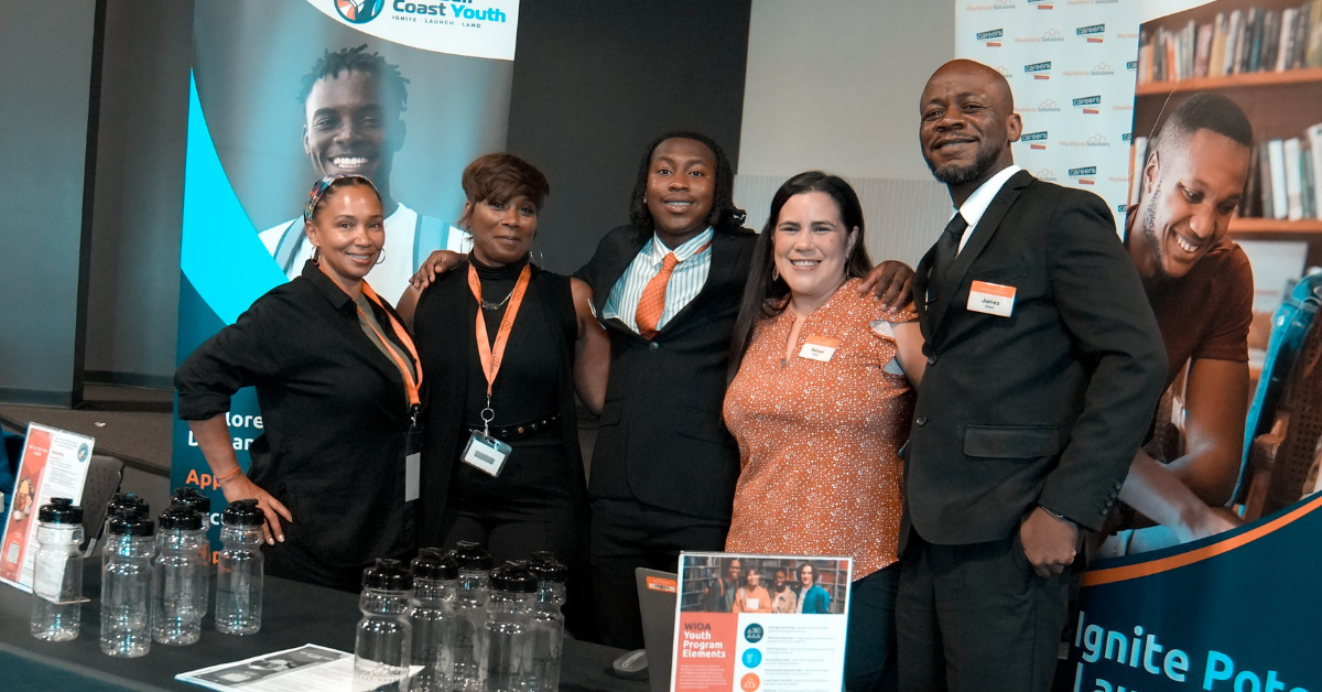 Workforce professionals pose together at a Hire Gulf Coast Youth career and workforce development event.