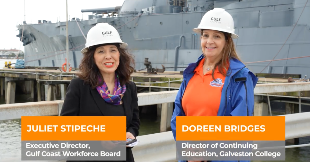 Gulf Coast Workforce and Galveston College Partnership Juliet Stipeche of the Gulf Coast Workforce Board and Doreen Bridges of Galveston College wear Gulf Copper hard hats while standing at a shipyard.