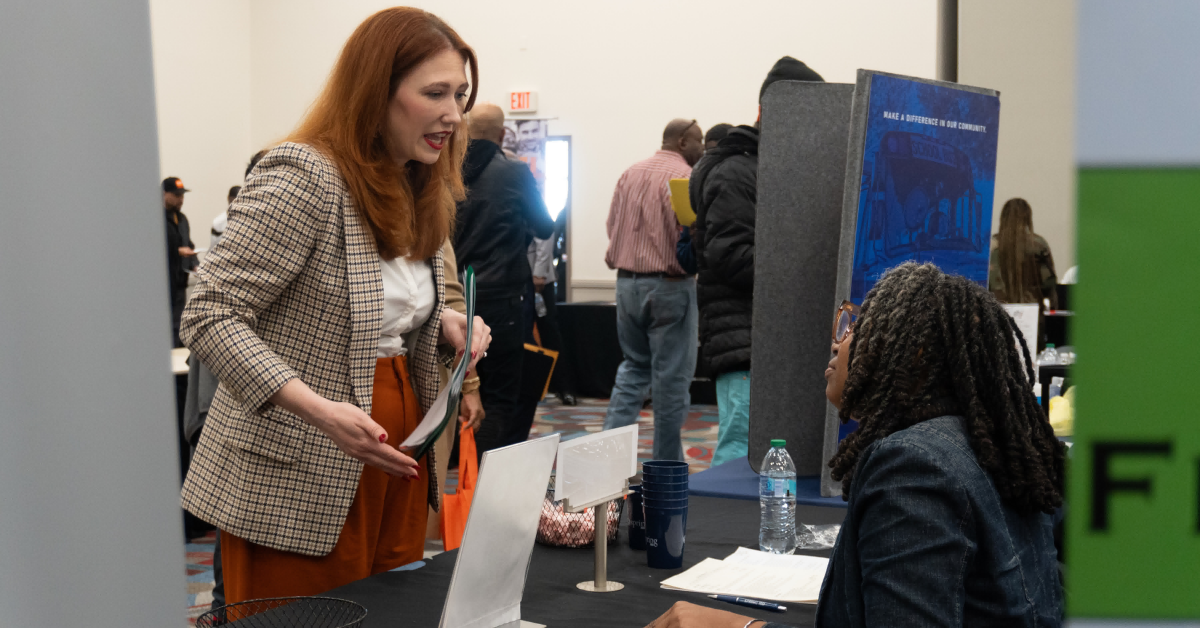 Job seeker speaking with an employer representative at a Gulf Coast Workforce career fair.
