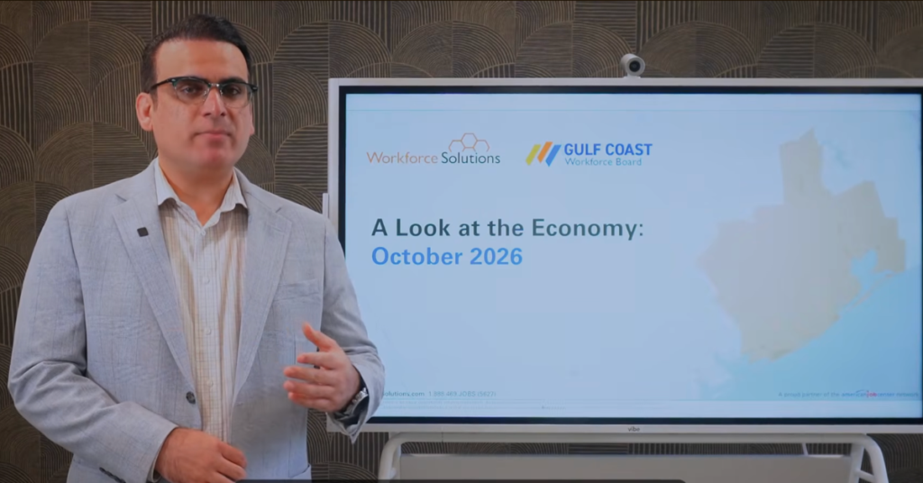 Gulf Coast Workforce Board economist Muhammad Emid Dizad presents the October 2026 edition of A Look at the Economy, standing beside a screen displaying the presentation title and Gulf Coast Workforce Board logo.