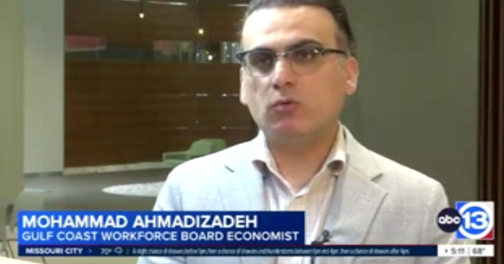 Mohammad Ahmadizadeh, economist for the Gulf Coast Workforce Board, speaks during an ABC13 news interview. He is wearing glasses and a light gray blazer, with his name and title displayed on screen.